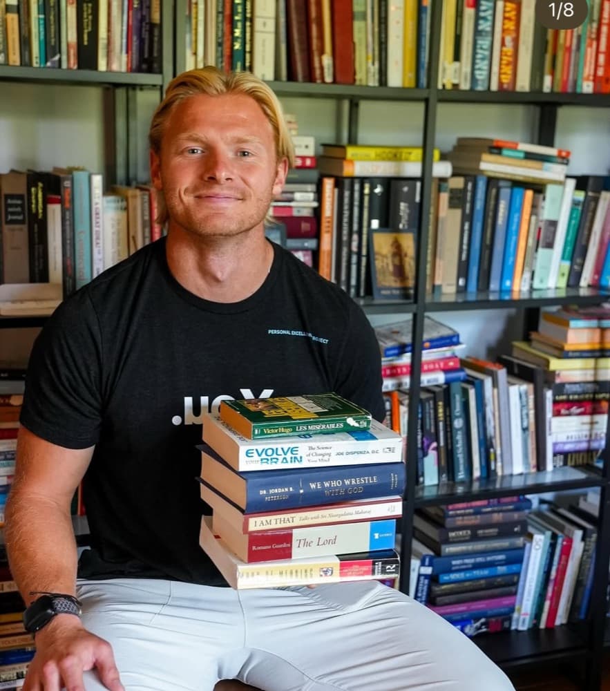 Harrison Schertzinger holding a stack of books